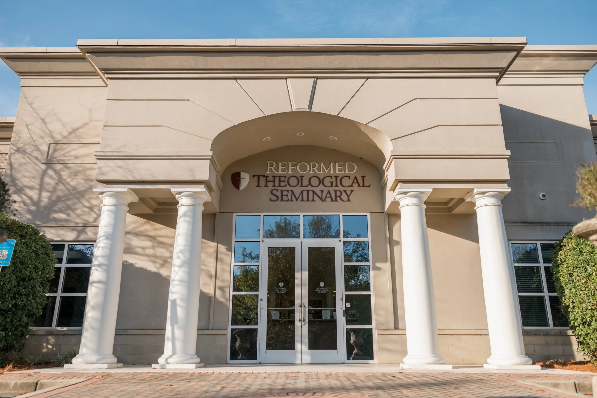 Front entrance of Reformed Theological Seminary Atlanta campus building with columns and glass doors