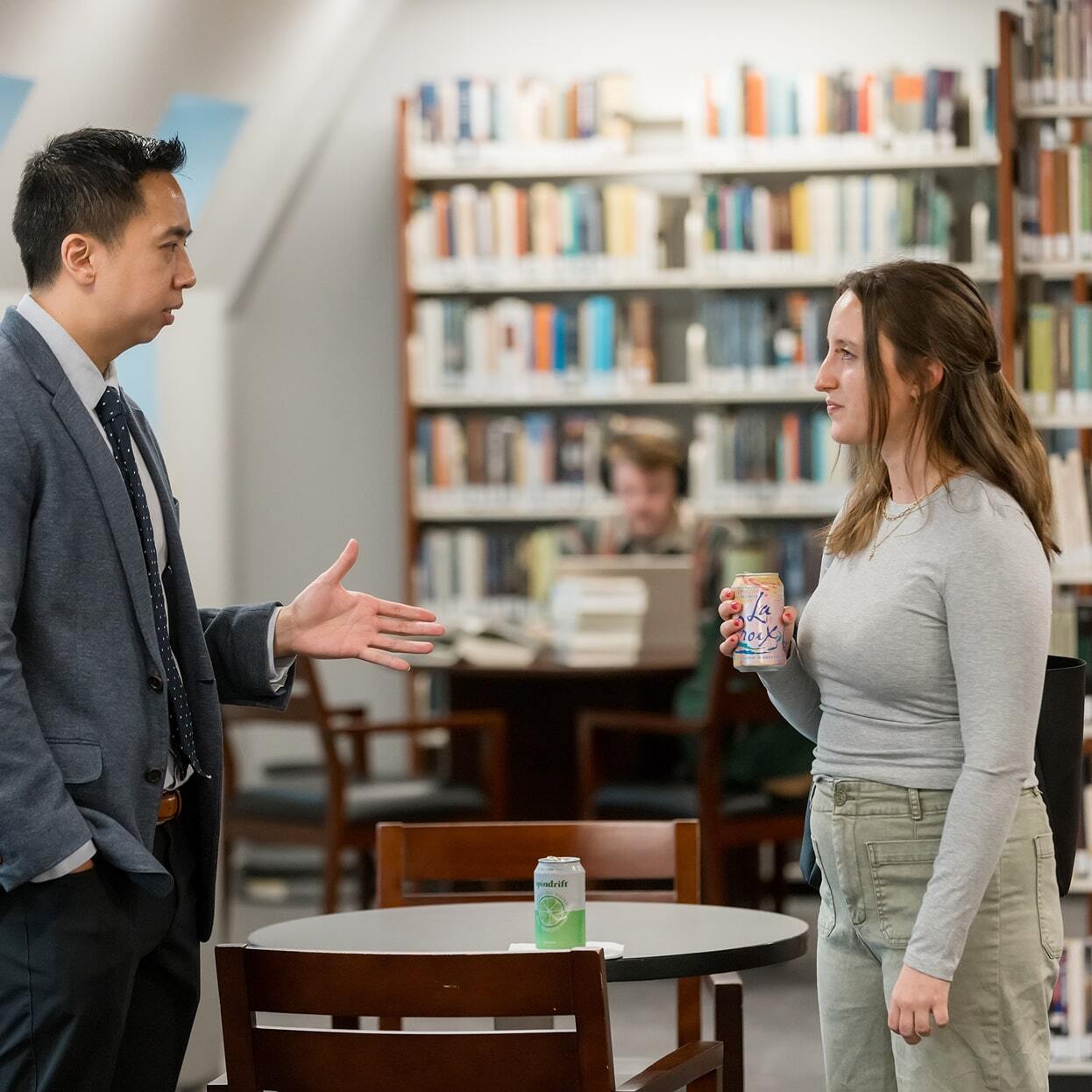 Student and professor talking together in the library at Reformed Theological Seminary.