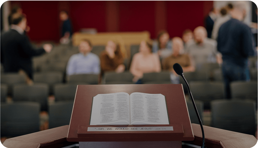 Open Bible on a podium in a chapel.