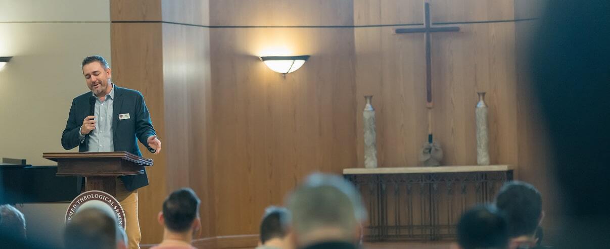 Speaker presenting during a practical ministry session in the Orlando chapel.