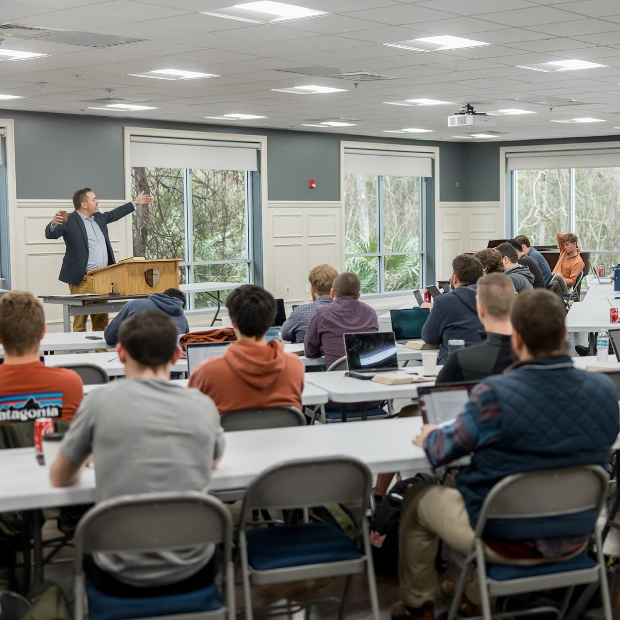 Instructor lecturing to students seated in an Orlando classroom.