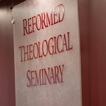Interior wall sign displaying the words “Reformed Theological Seminary” in raised lettering
