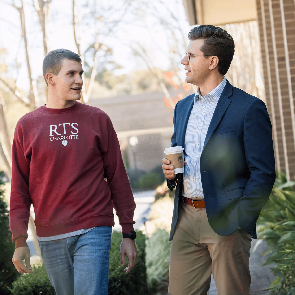 Pastor and a Student walking and talking outside