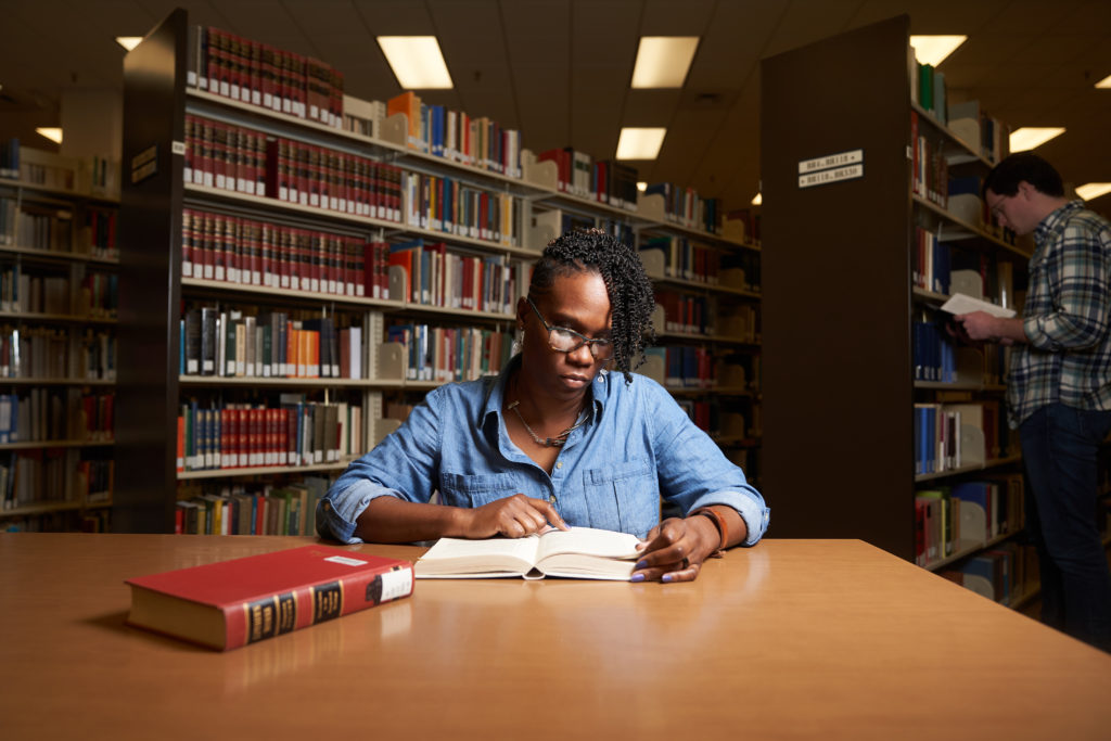 Woman studying at library table